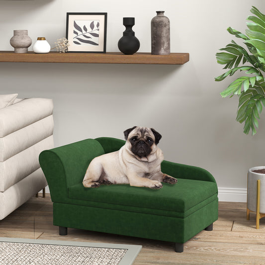 Pug lying on a green pet bed in a living room setting with a shelf and plant in the background.